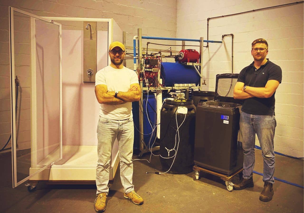 Drytong's first water recycling prototype alongside his founder and first engineer.